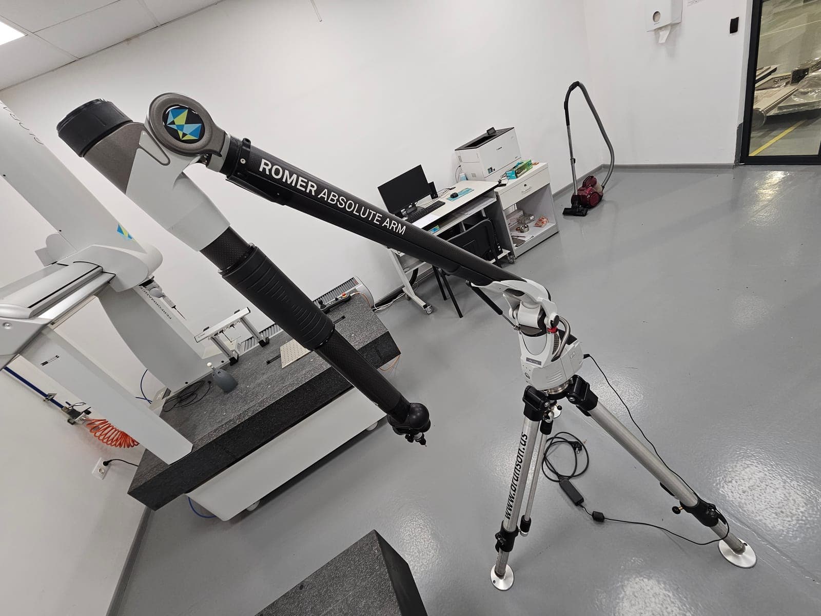 ROMER Absolute Arm 7730 on its tripod, arm extended