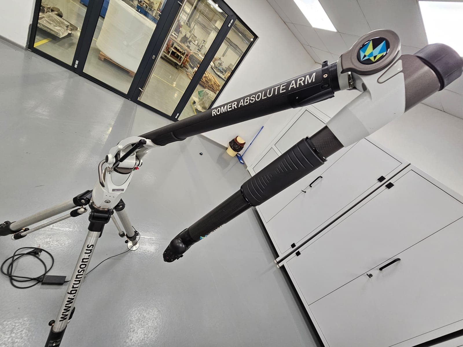 The arm from the other side, with the ROMER Absolute Arm lettering and carbon-fiber tubes